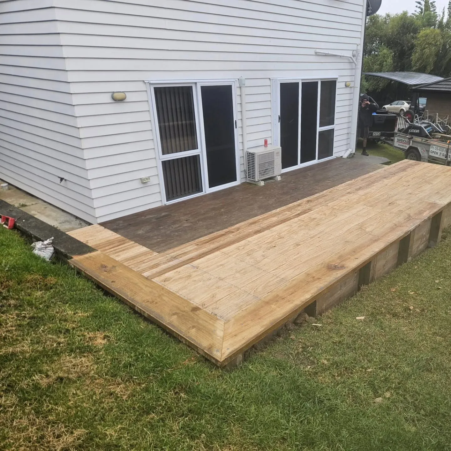 L-shaped pine deck extension on a weatherboard home, Auckland
